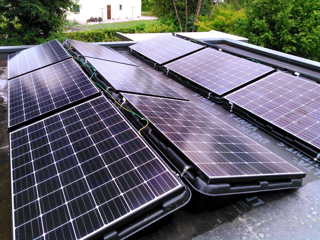 Installation de panneaux solaires sur une toiture en tuiles.